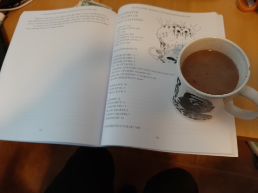 Kuvassa kirjan aukeama ja kuppi kaakaota. Taitto on huonoa.