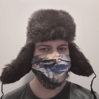 kuvassa krijoittaja Karpomaisessa karvalakissaan ja erähenkinen kasvomaski kasvoillaan